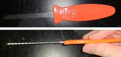 A knife--short, narrow, thick, with two edges featuring different sized sawteeth.