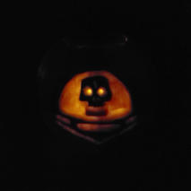 A glowing orange image of a skull in a space helmet.