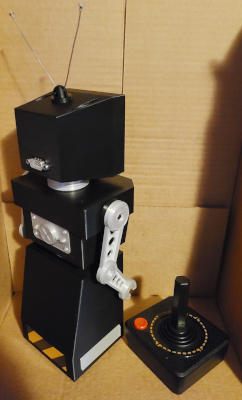 A back view of the same robot. There is a wedge-shaped socket in the back of the head.